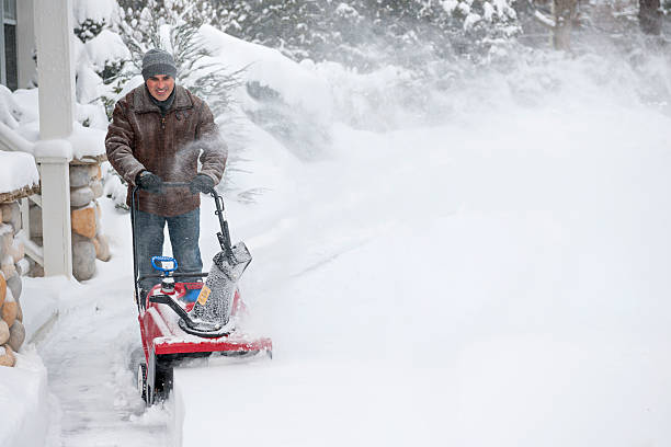 istock Man clearing driveway with snowblower 477682555