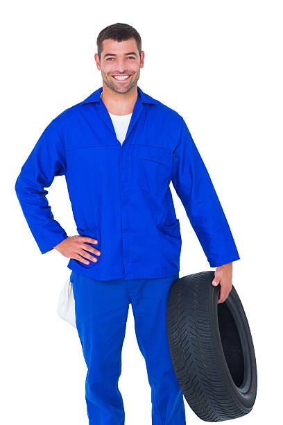 istock Smiling male mechanic holding tire 477682660