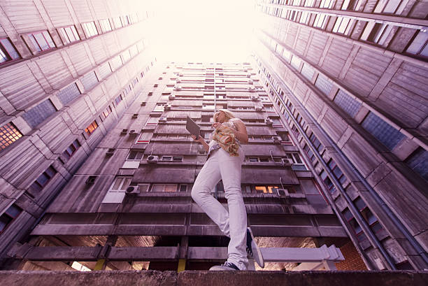istock Beautiful girl in building passage using tablet 477682936
