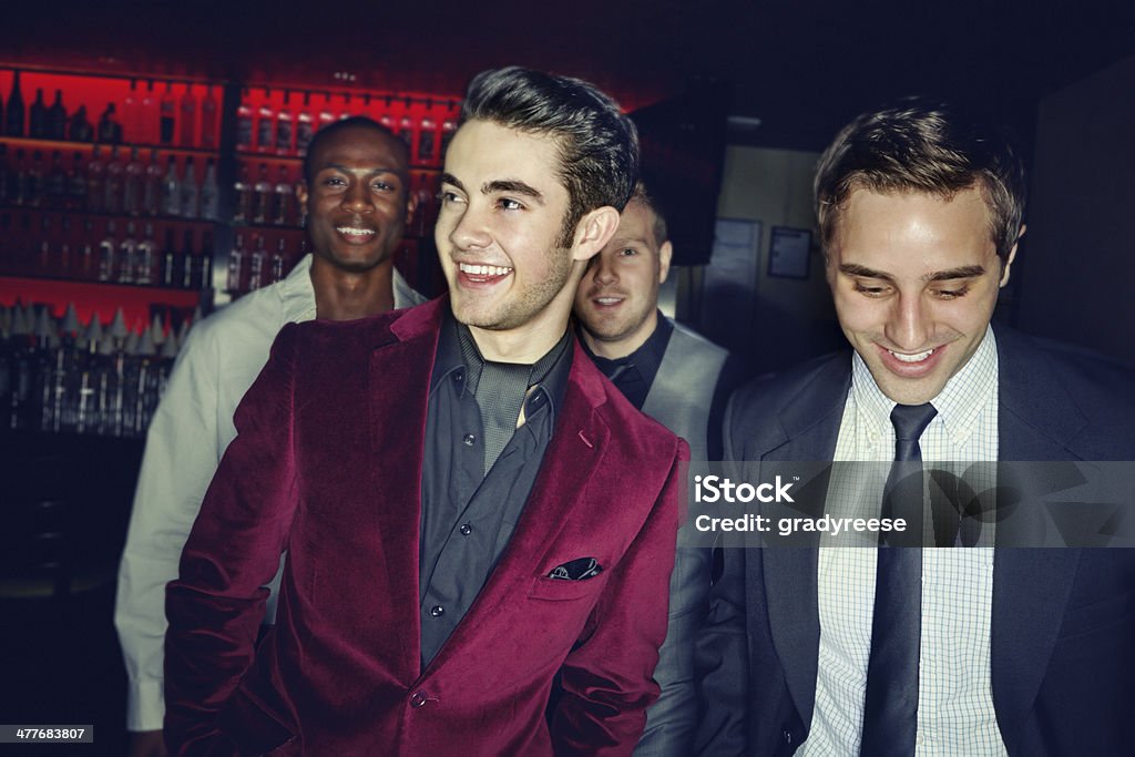 Scoping the place for talent A group of smartly dressed men arriving at a nightclub together Stag Night Stock Photo