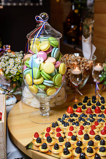 istock Glass vase with macaroon and cakes with berries 477685248