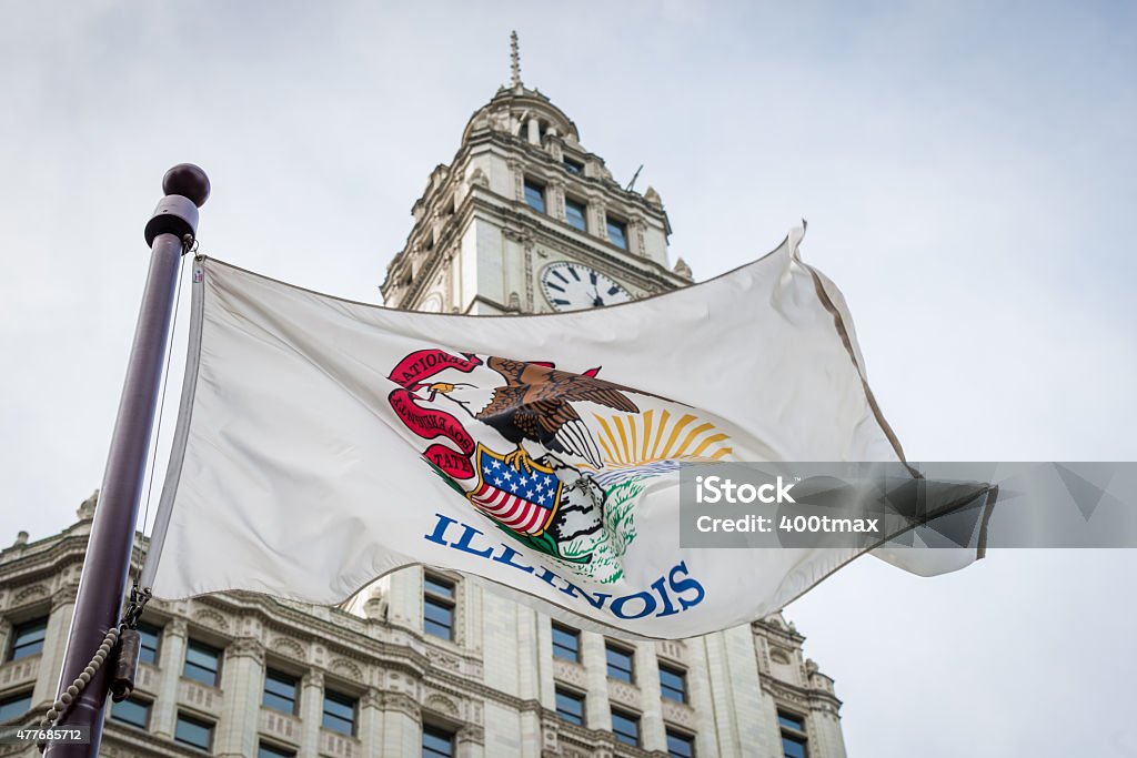 Illinois An Illinois state flag waving in the four ground of the iconic Wrigley building. Illinois Stock Photo