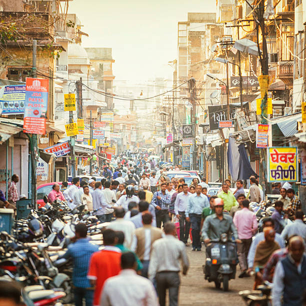 Street Crowded with People in Jaipur, India Crowded street full of people in Jaipur, Rajasthan, India.  india crowd stock pictures, royalty-free photos & images