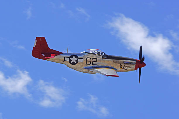 P-51 Mustang "Red Tail" airplane flying at air show Chino, California,USA- May 2,2015. Vintage WWII P-51 Mustang airplane flying at 2015 Planes of Fame Air Show in Chino, California. The 2015 Planes of Fame Air Show features 3 days of vintage and modern military aircraft performing and many static aircraft displays open to the public. p51 mustang stock pictures, royalty-free photos & images