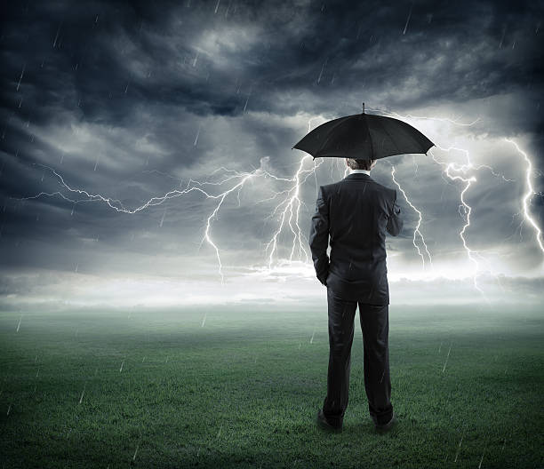 istock crisis and risk business - man with umbrella 477686346