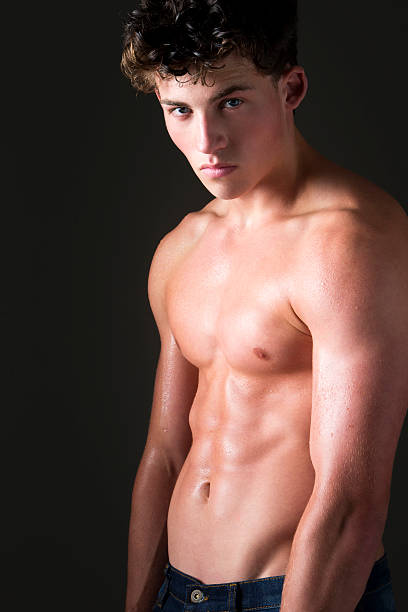 Portrait of Thai teen boy showing off his Muscles