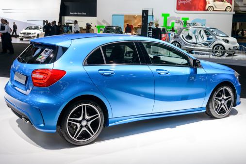Brussels, Belgium - January 14, 2014: Mercedes-Benz A-Class compact hatchback on display at the 2014 Brussels motor show. People in the background are looking at the cars.