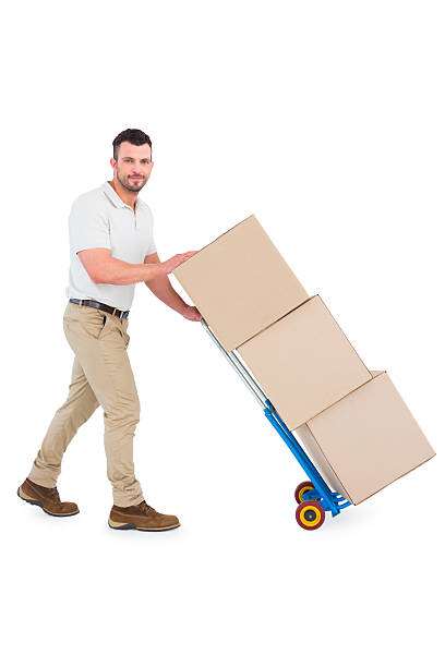 istock Delivery man pushing trolley of boxes 477689604