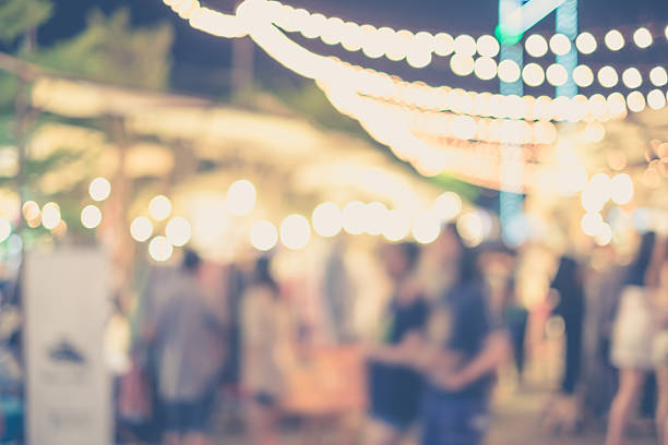 Abstract blurred people in street market Abstract blurred people in night market or open street market for background fete stock pictures, royalty-free photos & images