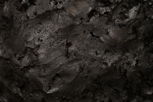 Close-up of black soil texture background.