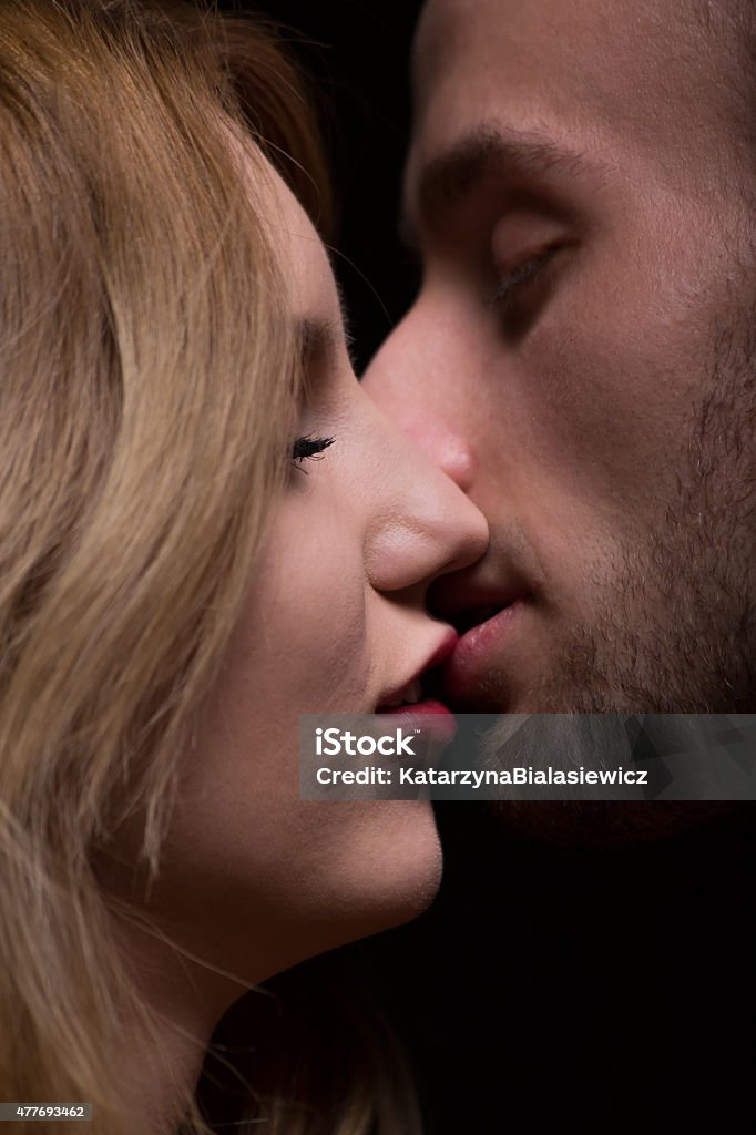 Woman kissing her boyfriend Portrait of sensual woman kissing her boyfriend 2015 Stock Photo