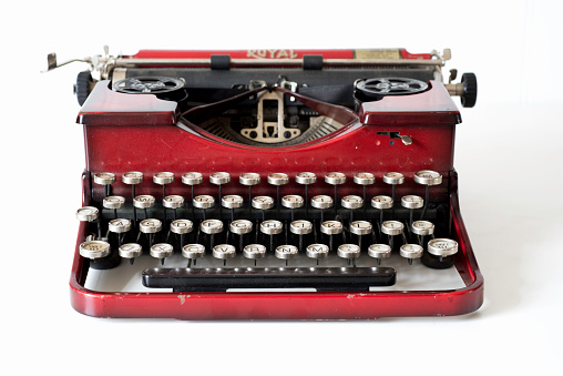 Annapolis, USA - January 29, 2015: A vintange red portable Royal typewriter from the 1930's on a white background.