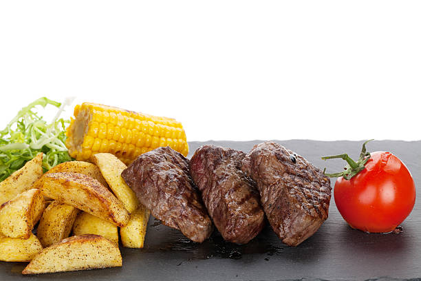 istock Steak with grilled potato, corn, salad and tomato 477693950