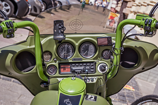 Szczecin, Poland - June 11, 2015:Harley Davidson custom motorcycle handlebar with radio and GPS equipment standing on the sidewalk next to to the store, Szczecin, Poland. Harley Davidson is an American motorcycle manufacturer. Founded in Milwaukee, Wisconsin, during the first decade of the 20th century