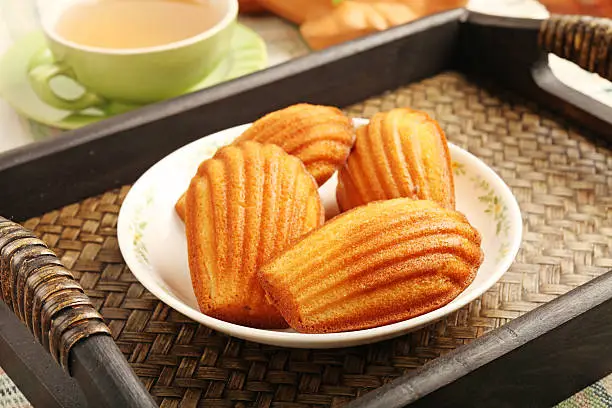 Madeleine cookie and cup of tea.