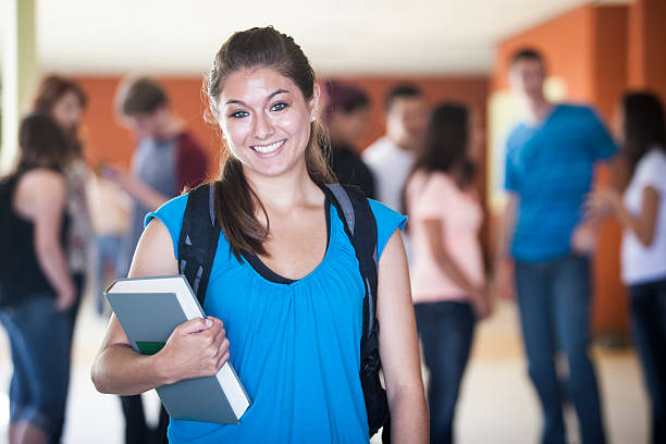 istock Young Female Student with Friends in Background 477694666