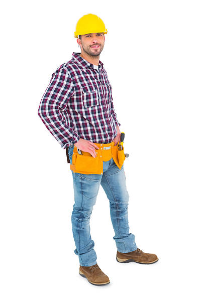 istock Confident handyman standing with hands on hips 477695008