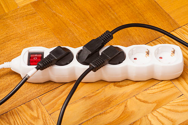 istock Many plugs plugged into electric power bar on floor 477696094