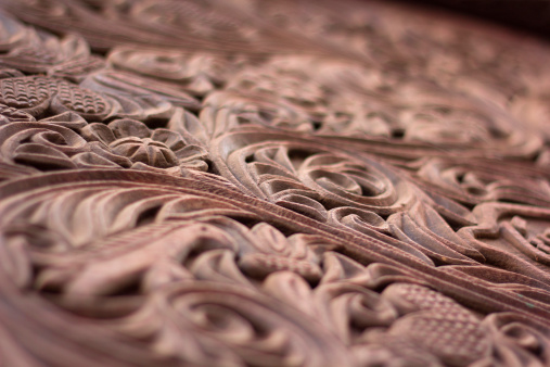 Close up of the intricate wood carving traditional to the Swahili coast of Africa, often used in door frames. Shallow depth of field.  