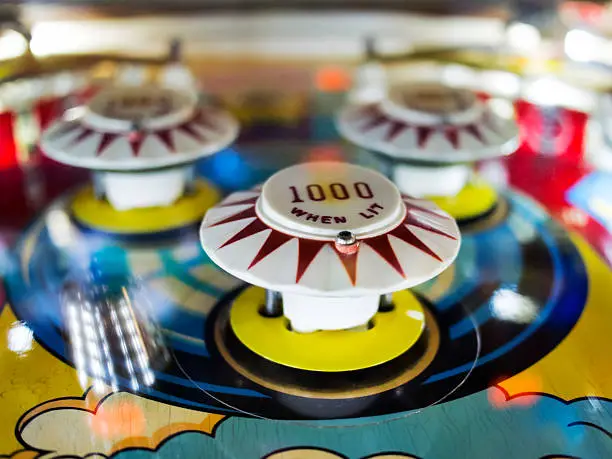 Photo of Antique Pinball Machine with Ball in motion