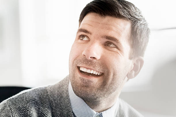 istock Happy businessman looking away in office 477701616