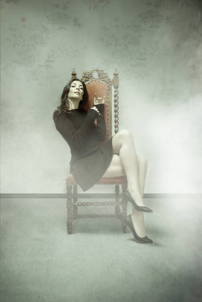 istock nice model sitting in a royal chair 477702177