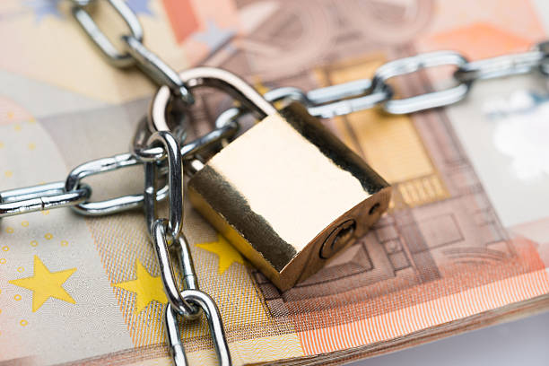istock Chain And Padlock Around Euro Banknotes 477702406