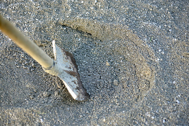 istock Old rusty shovel in sand for mixing concrete 477703294