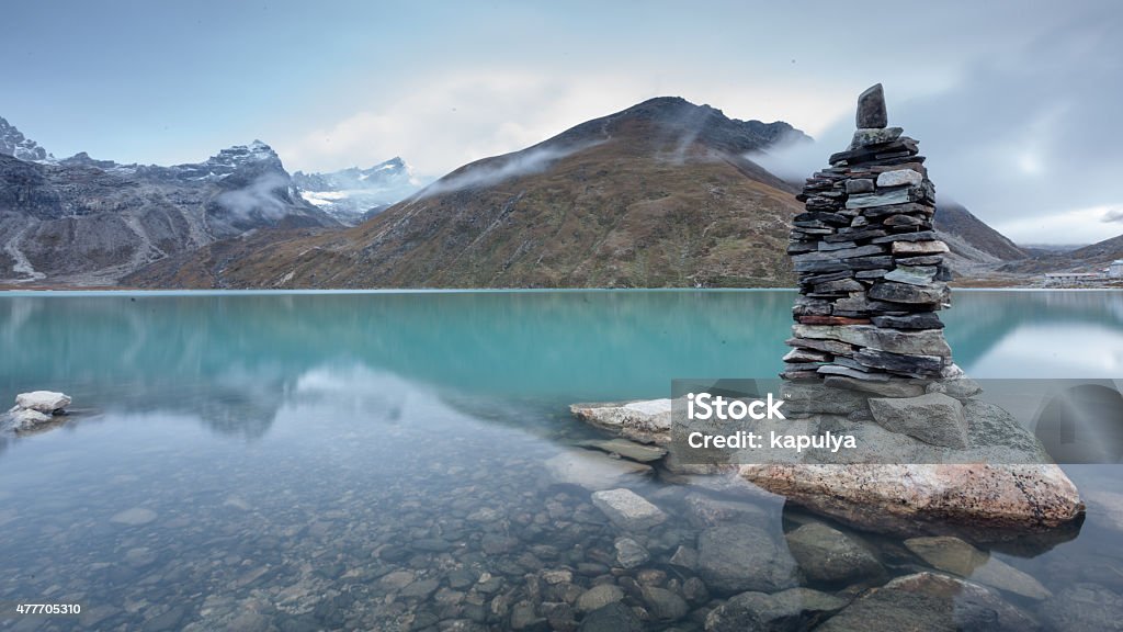 Green lake between mountains in cloudy day Gokyo Lake Stock Photo