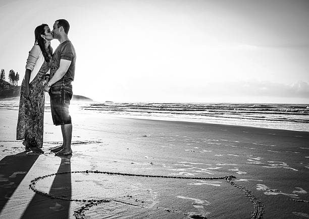 Beijo Romantico - Brazil- Florianópolis April 2015 Photo of a couple in love on Joaquina beach in Florianópolis Santa Catarina, Brazil. joaquina beach in florianopolis santa catarina brazil stock pictures, royalty-free photos & images