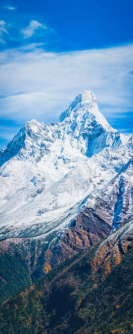 Green forests and rocky ravines below the snow capped spire of Ama Dablam (6812m) deep in the Everest National Park of the Nepal Himalaya, a UNESCO World Heritage Site. ProPhoto RGB profile for maximum color fidelity and gamut.