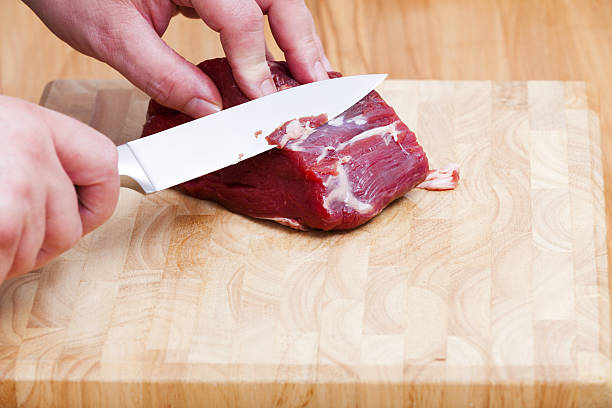 istock Piece of raw beef tenderloin and a kitchen knife 477706165