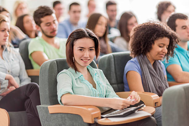 istock Asian female student in lecture hall looking at camera. 477706366