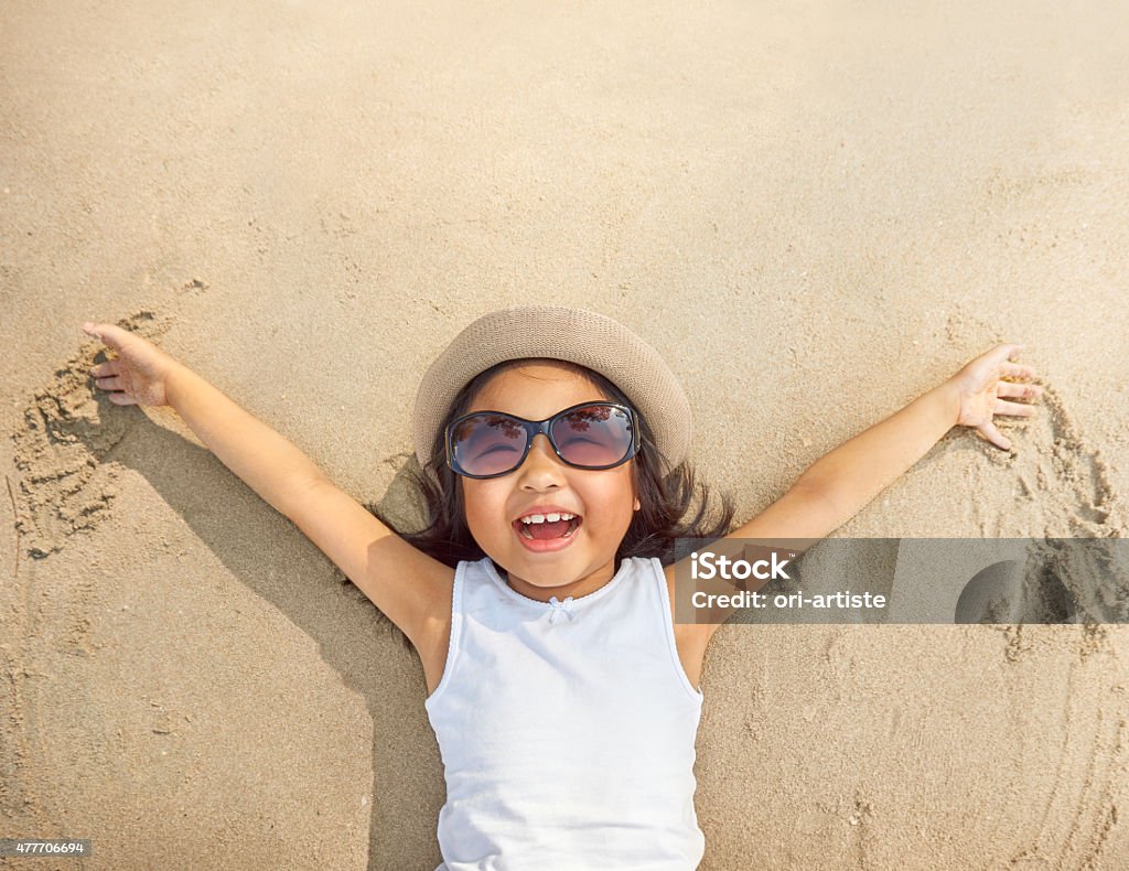 Fun on the beach Little cute girl enjoying the beach Child Stock Photo