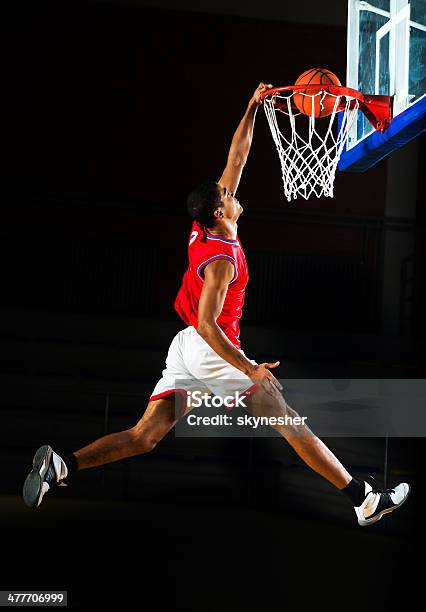 Basketball Player Slam Dunking The Ball Stock Photo - Download Image Now - Basketball - Sport, Slam Dunk, Basketball - Ball