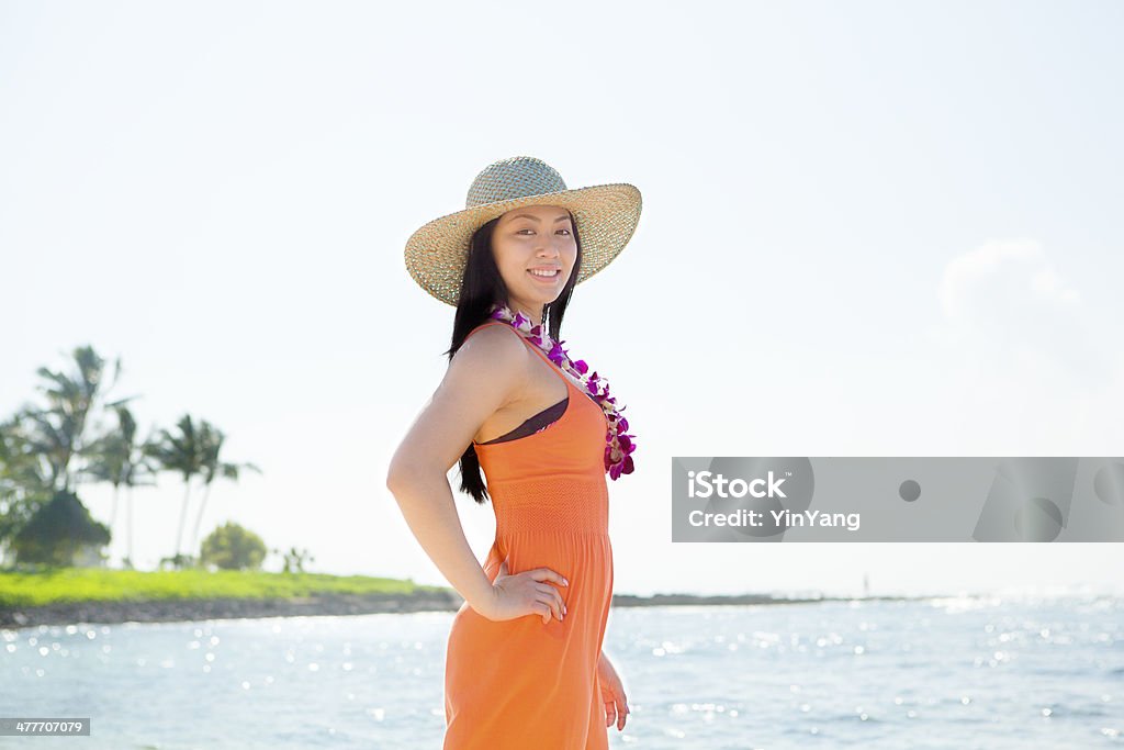 Tropical Beach Vacation in the Hawaiian Islands Subject: A woman reading a eBook on vacation in tropical paradise beach. Hawaii Islands Stock Photo