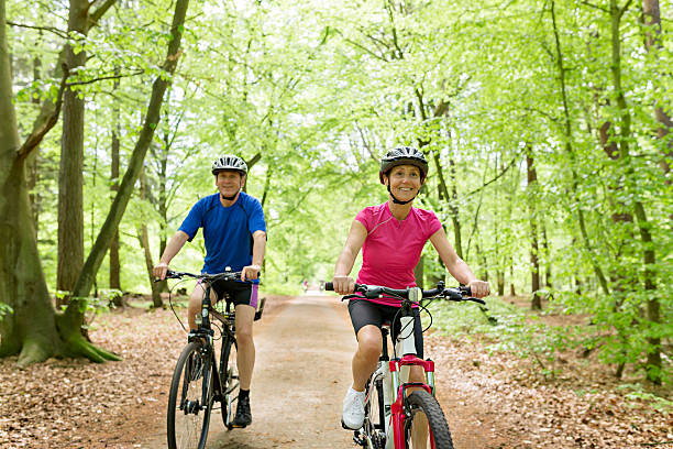 istock Active mature couple outdoors riding bikes in the nature 477707996
