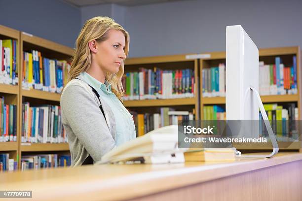 Pretty Librarian Working In The Library Stock Photo - Download Image Now - Librarian, Computer, Working