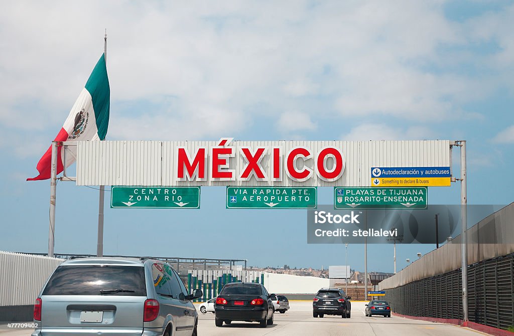 Crossing the Us - Mexico border to Tijuana A view of the highway entrance to Tijuana Baja California at the international US Border with Mexico in San Diego. Mexico Stock Photo