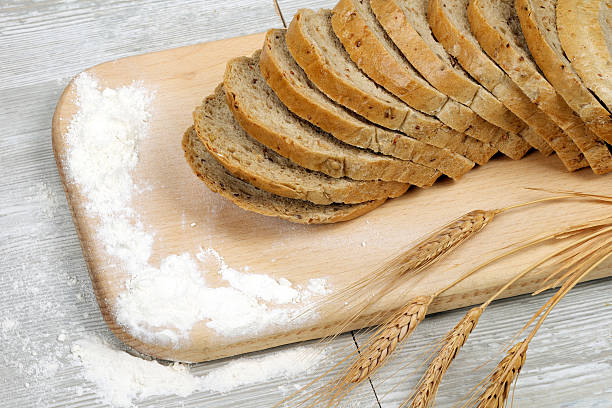 istock Rustic bread and wheat on an old vintage gray wood 477710692