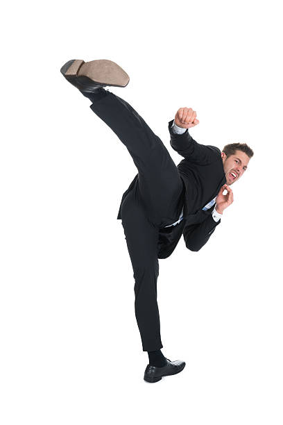 istock Businessman Kicking Over White Background 477710990