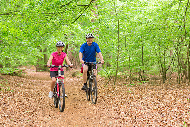 istock Mature couple with bicycle having fun 477711140