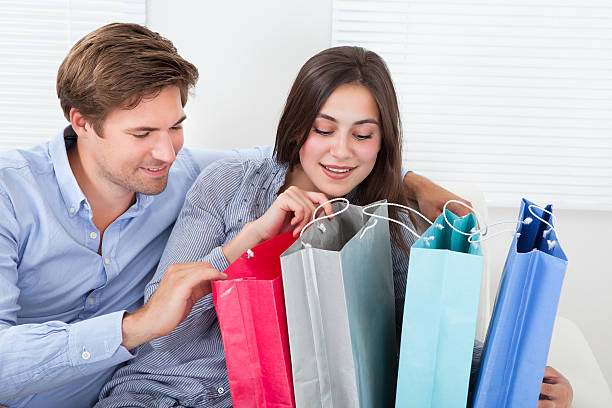 istock Couple Checking Shopping Bags At Home 477713900