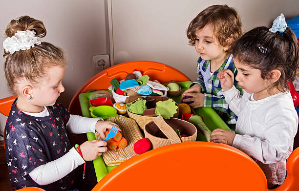 Preschoolers Preschoolers playing how to cook with toys food elementary student healthy eating schoolboy stock pictures, royalty-free photos & images