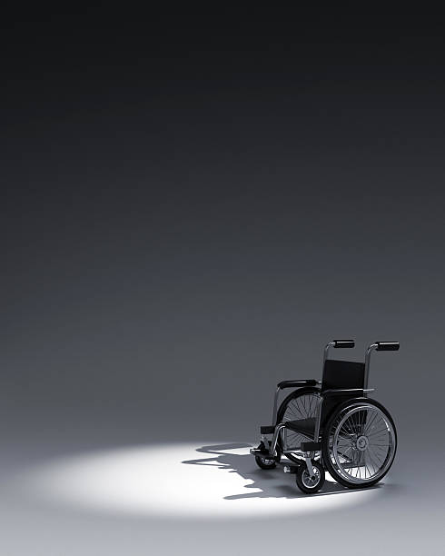 istock 3d Wheelchair in dark background 477714590