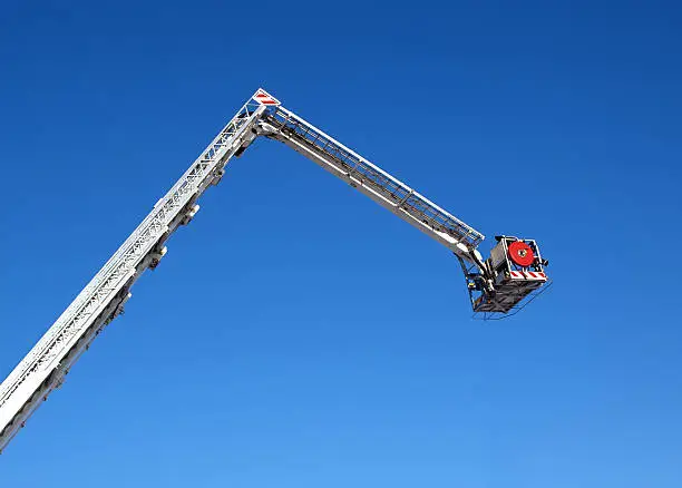 Fire carrycot with water cannon to extinguish a fire from a height on a background blue sky