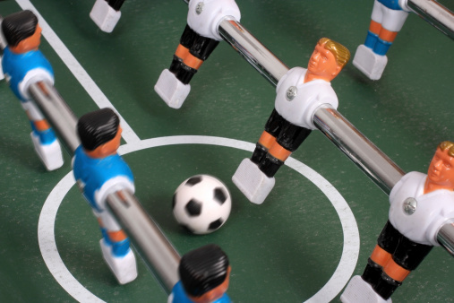 Start to play table soccer.