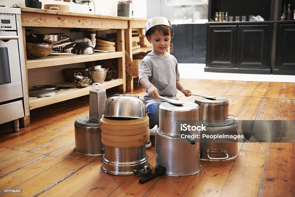 Getting ready to rock the crowd A young boy playing drums on pots and pans Child Stock Photo