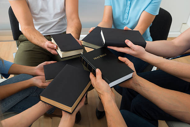 istock Group Of People Holding Holy Bible 477717410