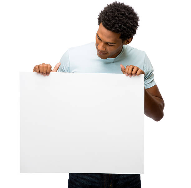 istock Casual latin man looking at white sign 477719447